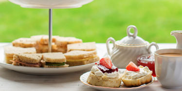 Cornish or Devonshire Method? Afternoon Tea stand featuring scones